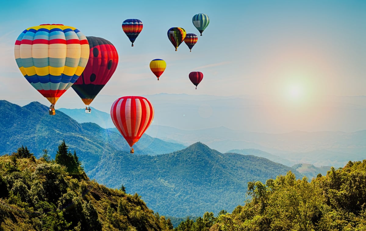 Beautiful view of mountain with hot air balloons on morning at Thailand