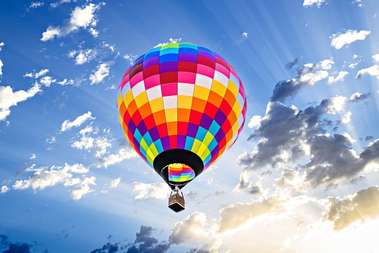 Colorful hot air balloon flying over blue sky