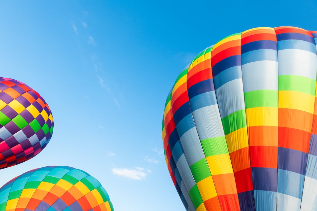 Colorful hot air balloons against the blue sky at sunny day. Travel and vacation concept