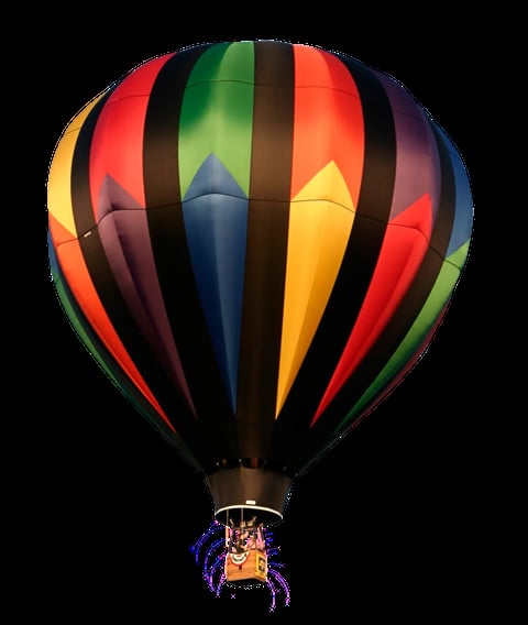 Colorful hot air balloon with red, yellow, green, and blue vertical stripes and a wicker basket suspended below against a black background