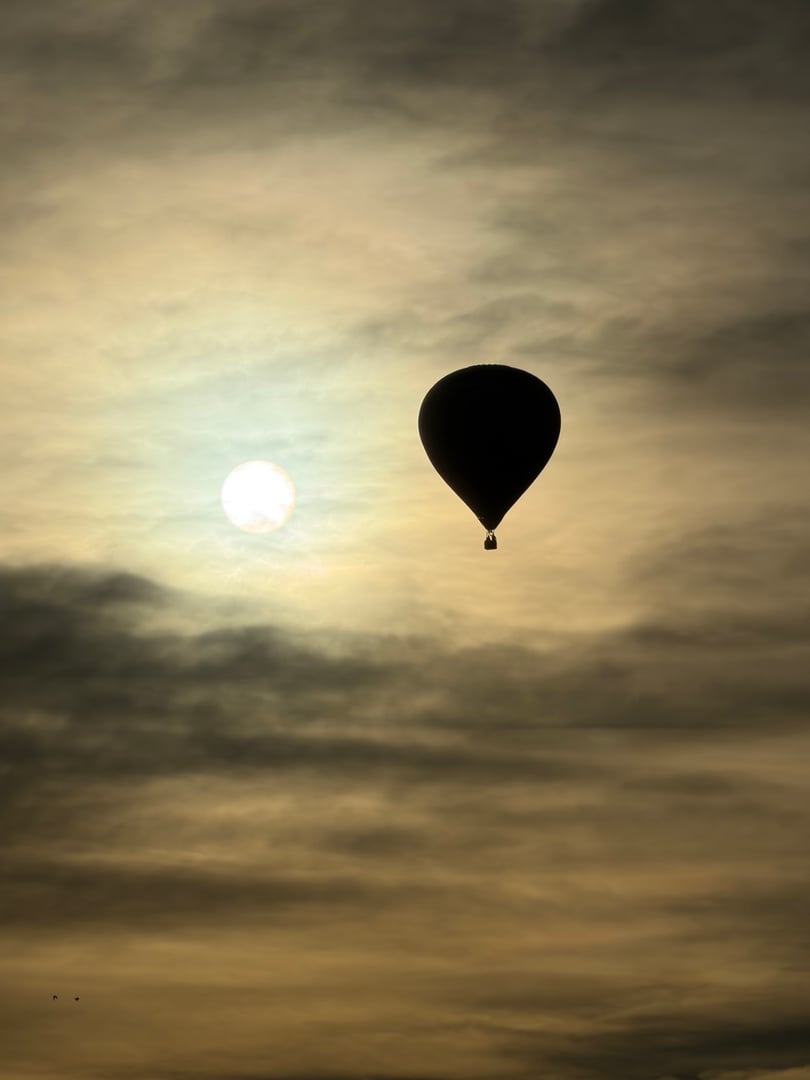 Hot air balloon in flight over the countryside